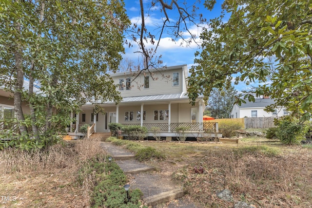 view of front of house with fence and a porch