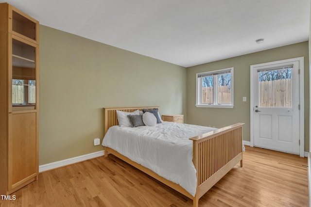 bedroom featuring light wood-style flooring and baseboards