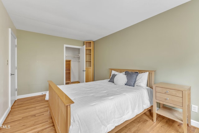 bedroom featuring wood finished floors and baseboards