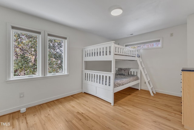 unfurnished bedroom with wood finished floors and baseboards