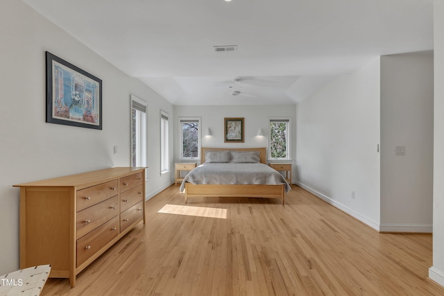 bedroom featuring light wood-type flooring, visible vents, and baseboards