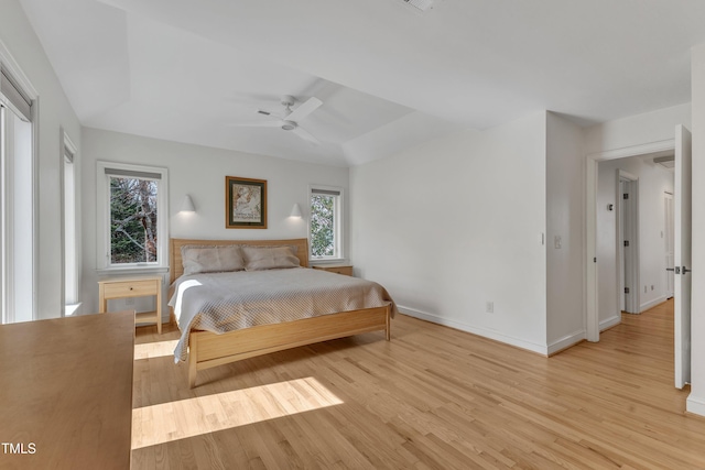 bedroom with light wood-style floors, baseboards, and a ceiling fan