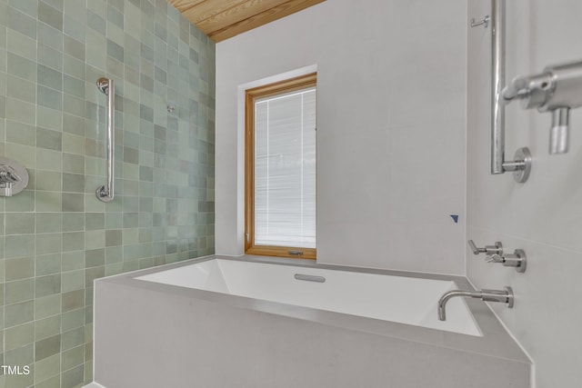 bathroom with a bath, tile walls, and tiled shower