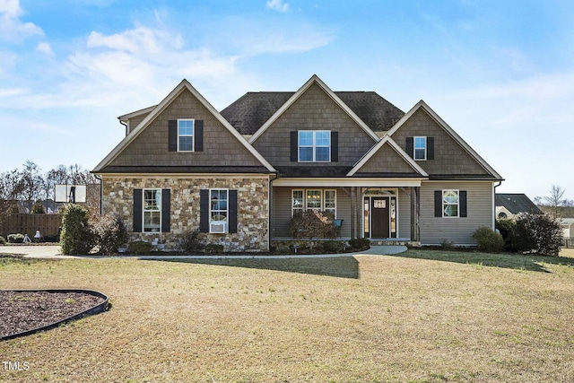 craftsman-style home featuring stone siding and a front lawn