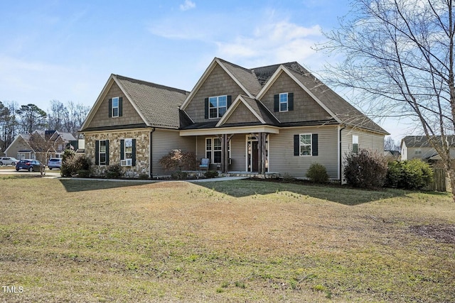 view of front of home featuring stone siding and a front yard