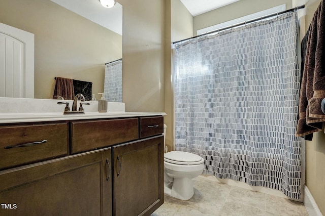 bathroom with toilet, tile patterned flooring, and vanity