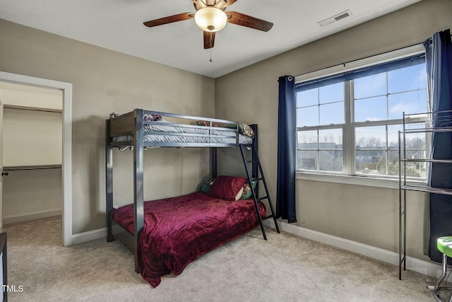 bedroom featuring light colored carpet, visible vents, ceiling fan, and baseboards