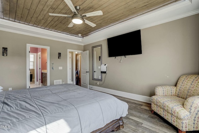 bedroom with baseboards, wood ceiling, ornamental molding, wood finished floors, and a tray ceiling