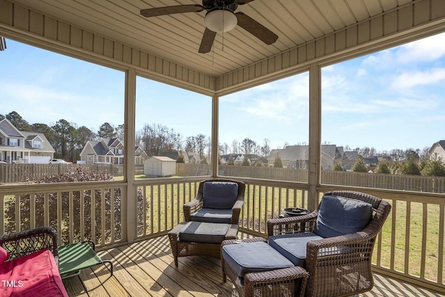 sunroom with plenty of natural light and a residential view