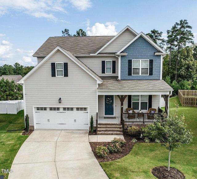 craftsman-style home featuring covered porch, fence, and a front yard