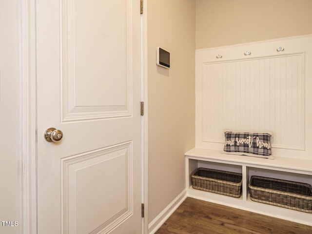 mudroom with dark wood-type flooring and baseboards