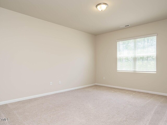 carpeted empty room with baseboards