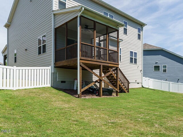 rear view of property with crawl space, a sunroom, and stairway