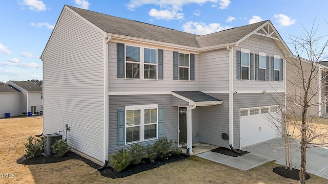 view of front of house featuring cooling unit, driveway, and an attached garage