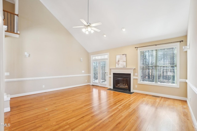 unfurnished living room with a fireplace with flush hearth, light wood-type flooring, and baseboards