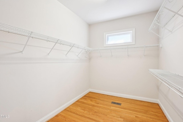 spacious closet with light wood-style flooring and visible vents