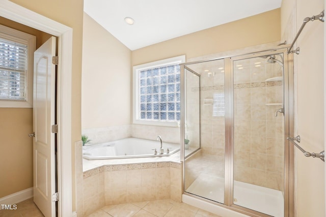 bathroom featuring a garden tub, a healthy amount of sunlight, and a stall shower