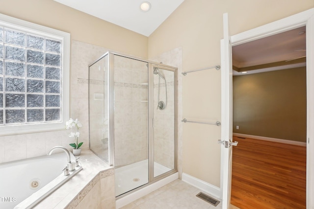 full bathroom with visible vents, baseboards, a stall shower, vaulted ceiling, and a jetted tub