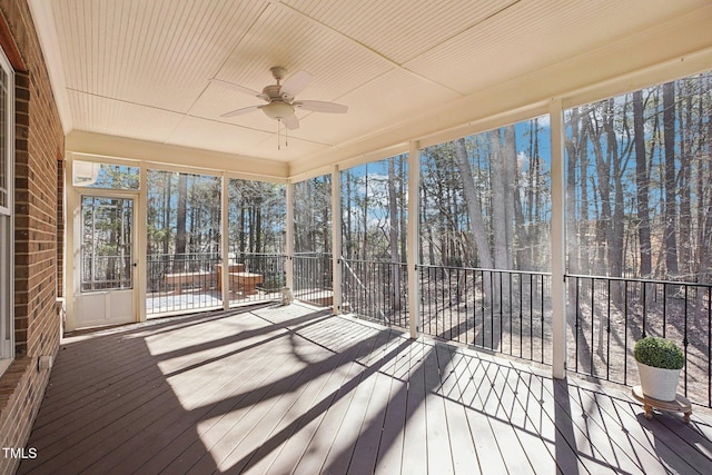 unfurnished sunroom with a ceiling fan