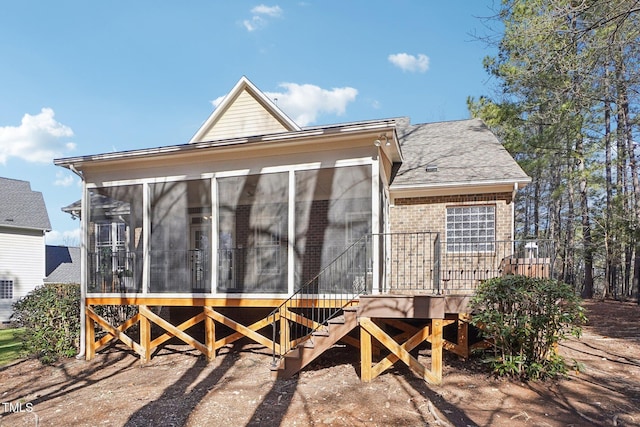 view of outbuilding with stairway and a sunroom