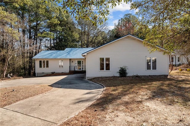 view of front of home with metal roof and crawl space