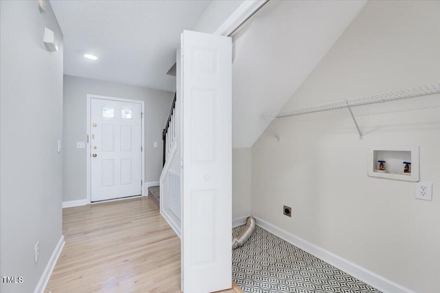 laundry room featuring washer hookup, light wood finished floors, electric dryer hookup, laundry area, and baseboards