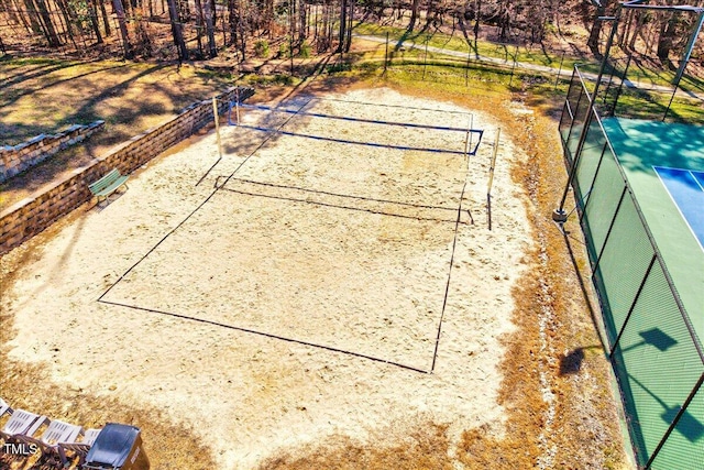 view of property's community featuring fence and volleyball court