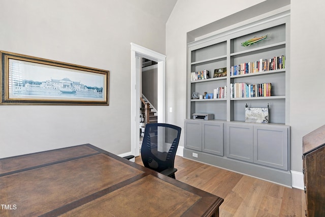 home office with baseboards and wood finished floors