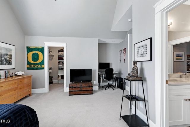 living area with lofted ceiling, baseboards, and light colored carpet