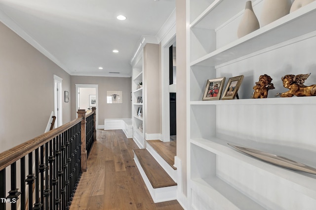 corridor with an upstairs landing, recessed lighting, crown molding, and hardwood / wood-style floors