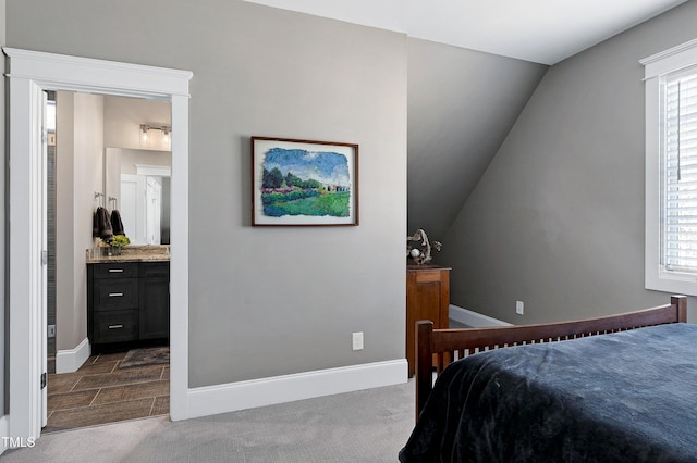 bedroom featuring dark colored carpet, multiple windows, and baseboards