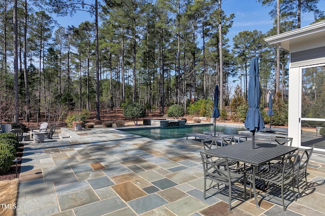 view of patio / terrace featuring a pool with connected hot tub