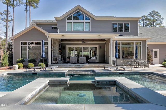 back of house featuring a pool with connected hot tub, a patio area, ceiling fan, and an outdoor living space