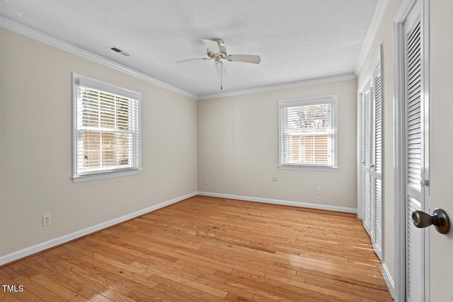 unfurnished bedroom with light wood-style floors, visible vents, and a textured ceiling