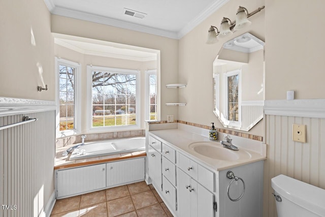 bathroom with toilet, a wainscoted wall, visible vents, and crown molding