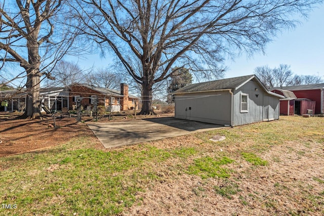 view of yard featuring an outbuilding and a patio area