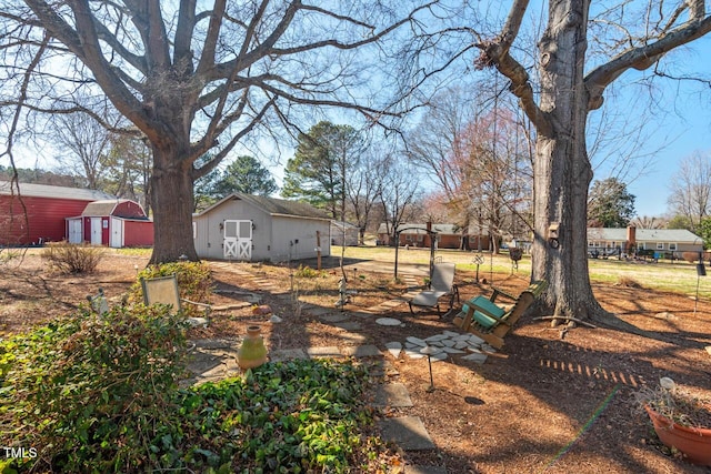 view of yard featuring a shed and an outbuilding