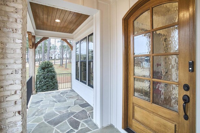 entrance to property featuring brick siding