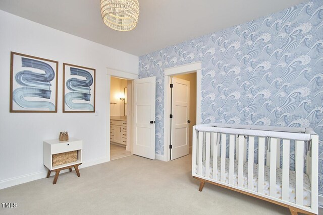 bedroom featuring wallpapered walls, carpet, baseboards, and ensuite bathroom