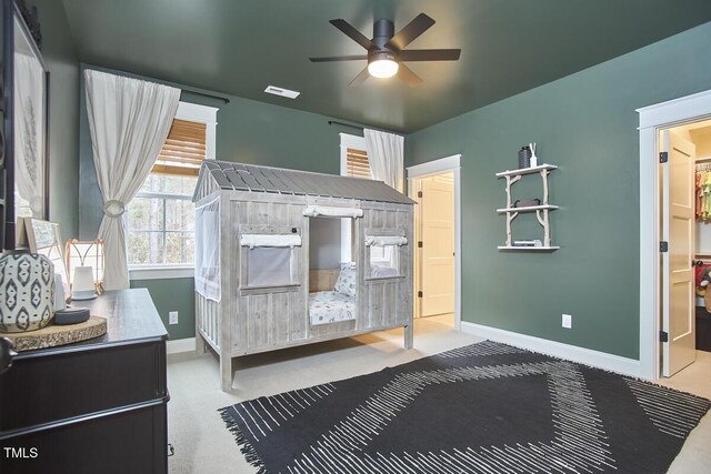 carpeted bedroom with ceiling fan, visible vents, and baseboards