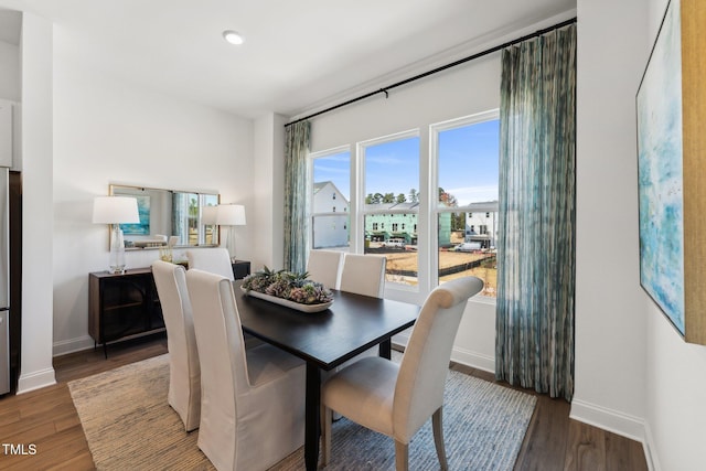 dining space featuring baseboards, dark wood-style flooring, and recessed lighting