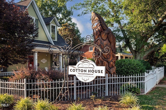 community / neighborhood sign with fence