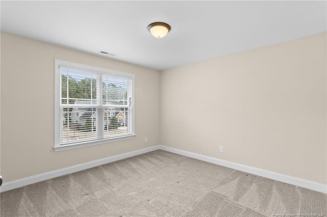 carpeted empty room with baseboards and visible vents