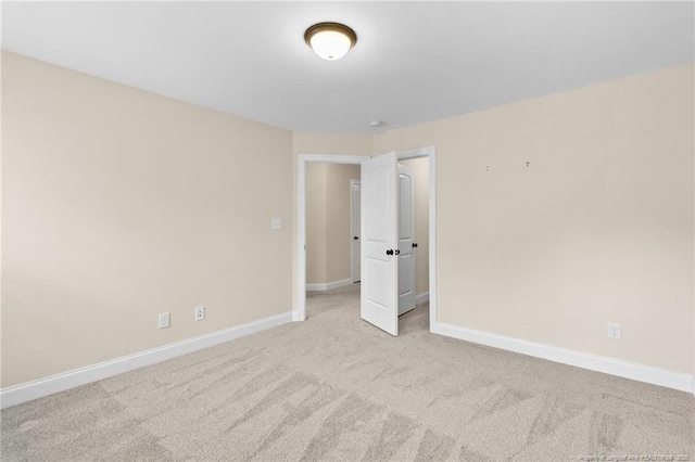 unfurnished bedroom with light carpet and baseboards