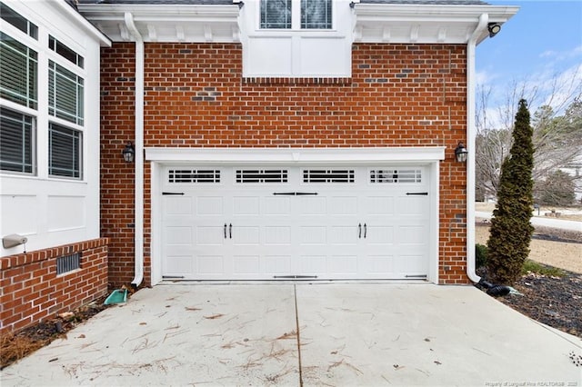 garage featuring concrete driveway