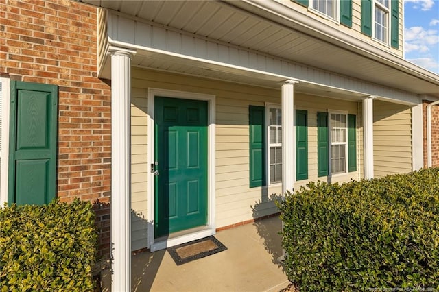 entrance to property with brick siding