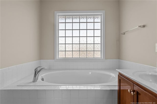 bathroom with vanity and a bath