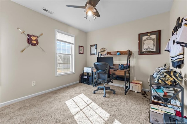 office area with ceiling fan, carpet flooring, visible vents, and baseboards