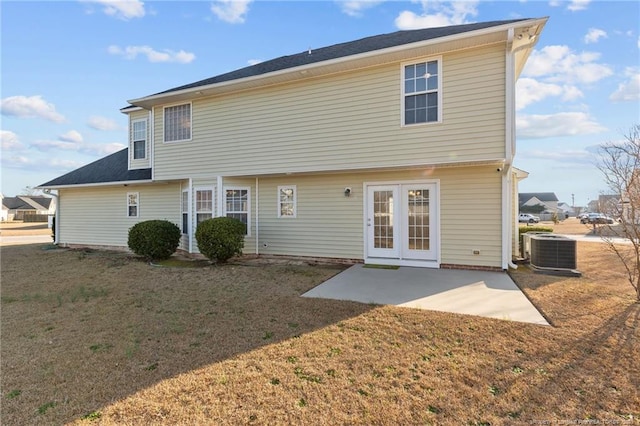 back of property with a yard, french doors, a patio, and central air condition unit