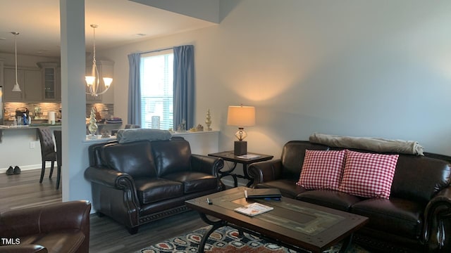 living area with an inviting chandelier and dark wood finished floors